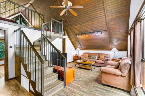 a living room with a staircase and a ceiling fan at Clutter Falls Retreat - Guest House in New Braunfels