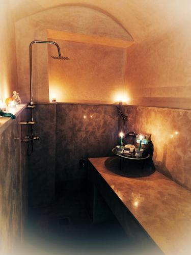a bathroom with a shower with a table in it at Riad Jô & Spa in Marrakesh