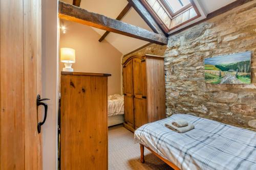 a bedroom with a bed and a stone wall at 2 Bed in Eggleston oc-l30452 in Middleton in Teesdale