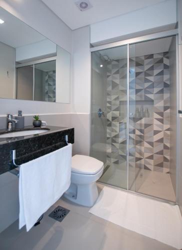 a bathroom with a toilet and a shower at Cityscape Views - New 2BR Retreat in Asunción
