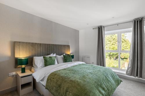 a bedroom with a large bed and a window at Regent Apartments, York in York
