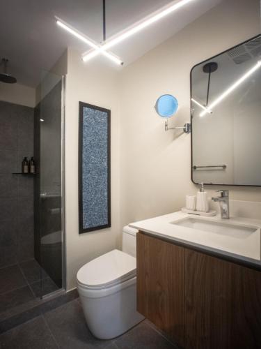 a bathroom with a toilet and a sink and a shower at Secrt Escalante Premium Studio AC in San Pedro