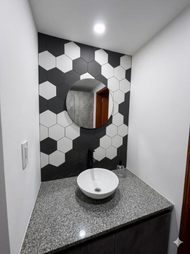 a bathroom with a sink and a mirror at Cabaña julian in Villa Berna