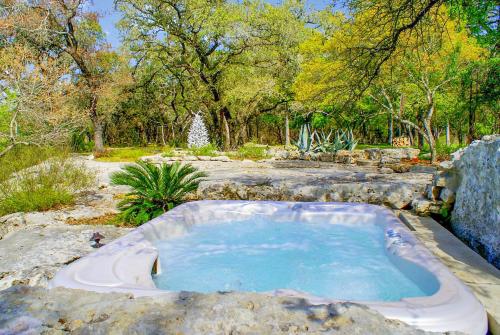a jacuzzi tub in the middle of a garden at Creekside Falls in Wimberley