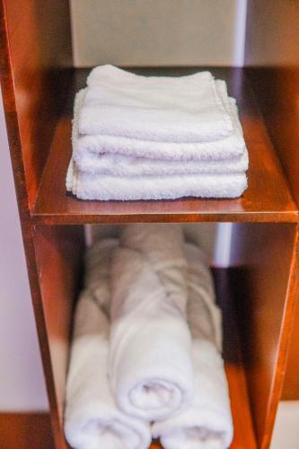 a shelf with white folded towels on it at Hotel Antigua Comayagua in Comayagua