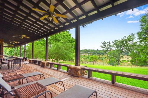 a large deck with tables and chairs on it at River Nest in Wimberley