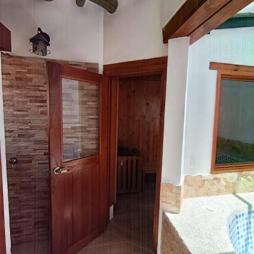 a hallway with a wooden door and a window at Hotel Boutique Villa Amonita in Villa de Leyva