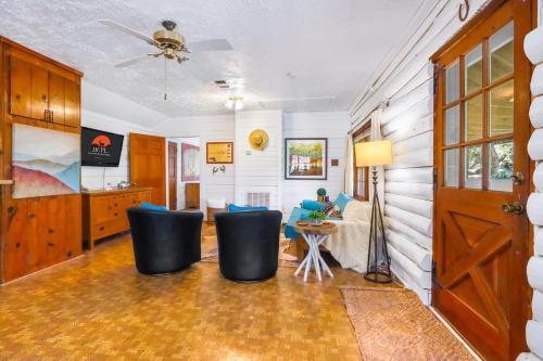a living room with a table and chairs at Creekside Vista Escape - Cabin in Wimberley