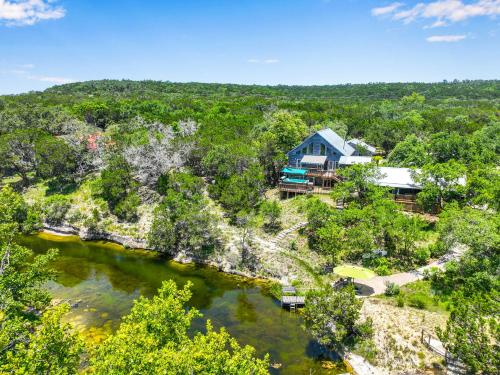 an aerial view of a house next to a river at Creekside Vista Escape - Cabin in Wimberley