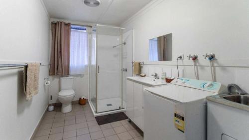 a bathroom with a shower and a sink and a toilet at Christian's Minde Jervis bay in Jervis Bay Village