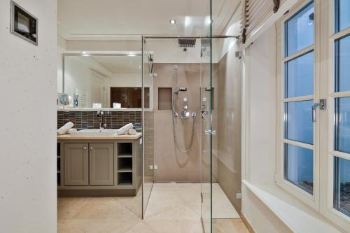 a bathroom with a shower and a sink at Sand Beach in Rantum