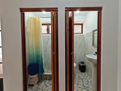 a bathroom with a shower and a sink at Casa Hormiga in Panajachel