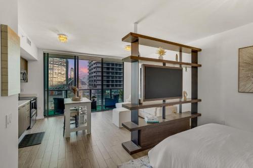 a bedroom with a bed and a flat screen tv at Azure Miami - Studio Apartment with Stunning City & Bay Views! in Miami