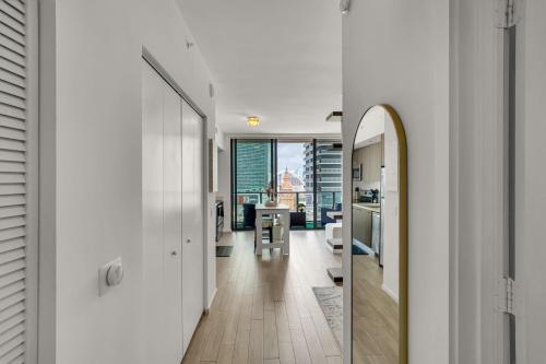 a hallway of a house with a kitchen and a dining room at Azure Miami - Studio Apartment with Stunning City & Bay Views! in Miami