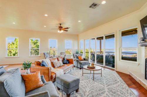 a living room with a couch and chairs and windows at Riviera Lake House in Canyon Lake