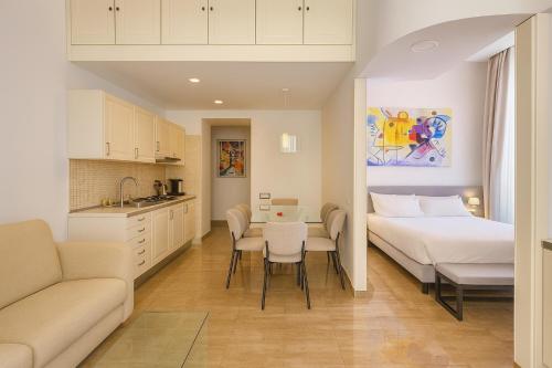 a bedroom with a bed and a table and chairs at Sanfelice 33 Luxury Suites in Naples