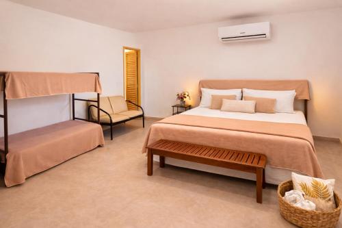 a bedroom with a large bed and a chair at Rekanto Canastra in Delfinópolis