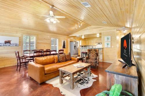 a living room with a couch and a table at Wimberley Log Cabins Resort and Suites- The Oak Lodge in Wimberley