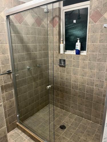 a shower with a glass door in a bathroom at SúperAnfitrión Coyoacán King 1 in Mexico City