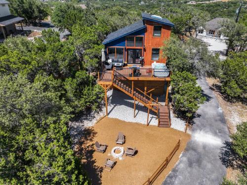 an overhead view of a house with a deck and chairs at Scenic Treehouse in Canyon Lake