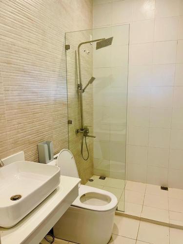 a bathroom with a shower and a toilet and a sink at Camp J Staycation in Cayucay