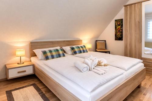 a bedroom with a large white bed with two pillows at Fewo Luv in Kühlungsborn