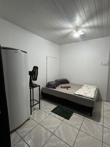 a room with a bed and a chair in it at Vila do Chaves Sr Barriga 70 in Itajaí