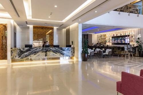a hotel lobby with a bar and a restaurant at Jasmine Grande Residence in Bangkok
