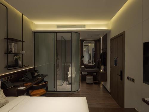 a bedroom with a bed and a bathroom at SEENERGY STAY Riverside in Phnom Penh
