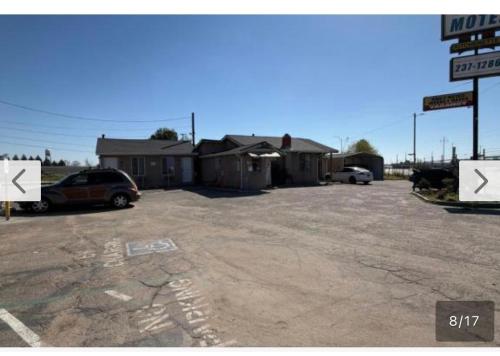a car parked in a parking lot next to a building at Ell Muir Motel in Fresno