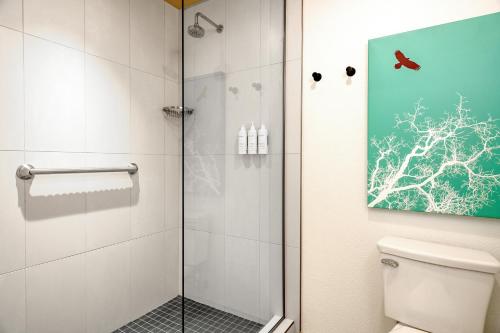 a bathroom with a shower with a glass door at Boundary Hotel By Terra Vi, Durango in Durango