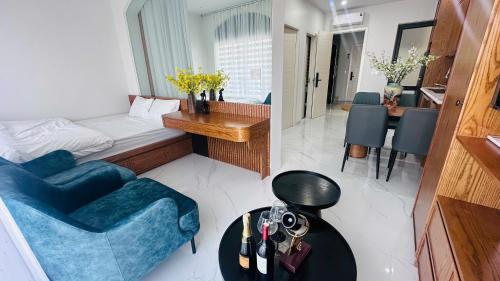 a room with a couch and a bed and a table at Sunrise Home in Xóm Niêm