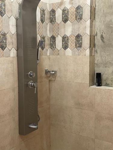 a shower with a glass door in a bathroom at Waypoint Resort and Apartments in Hikkaduwa