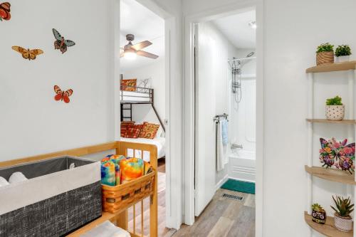 a bathroom with butterflies on the wall and a bedroom at Wild Rhodes in Wimberley