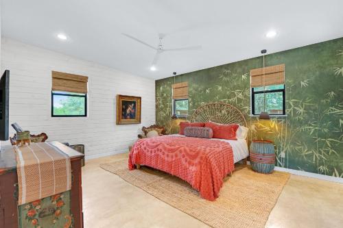 a bedroom with a bed and a large wall mural at Wild Candy-Plum Wild in Wimberley