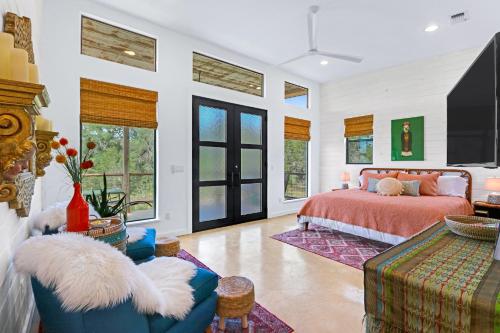 a bedroom with a bed and a tv in it at Wild Candy-Fruit Tramp in Wimberley