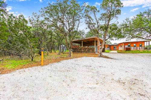 a dirt road with a house in the background at Wild Candy-Fruit Tramp in Wimberley
