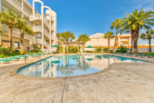a large swimming pool with chairs and palm trees at Casa Del Mar Unit 257 - Stunning Front Angle Views at the Gulf n Babe's Beach with Private Balcony WiFi in Galveston