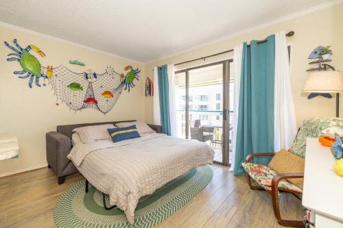 a bedroom with a bed and a chair and a window at Casa Del Mar Unit 257 - Stunning Front Angle Views at the Gulf n Babe's Beach with Private Balcony WiFi in Galveston