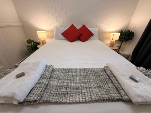 a bed with two pillows and two towels on it at Hotel Metropole Proserpine in Proserpine