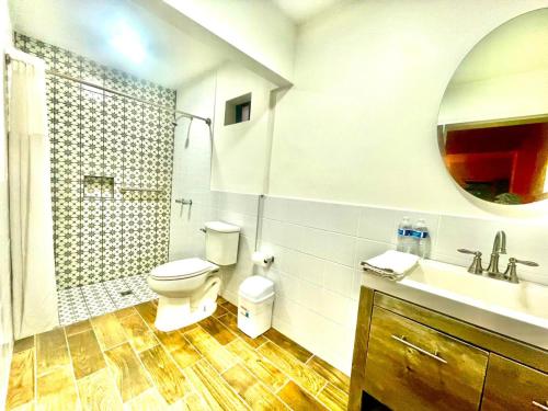 a bathroom with a toilet and a sink and a mirror at Stella del Mar in San Felipe