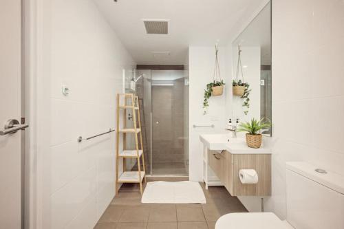 a bathroom with a shower and a toilet and a sink at Two Bedroom Unit in Central Adelaide in Adelaide