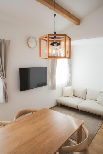 a living room with a table and a couch at Sa one ko Matsumoto Entire house Free parking 2cars in Matsumoto