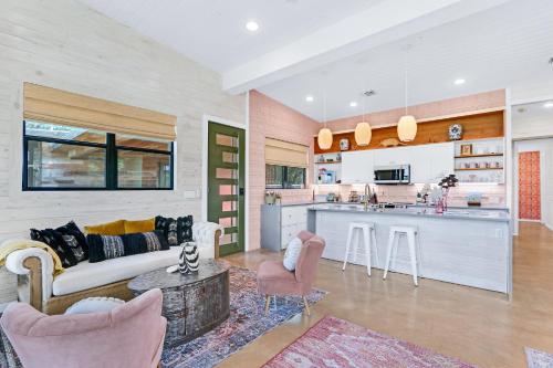 a living room with a couch and a kitchen at Wild Candy-Blue Yodel in Wimberley
