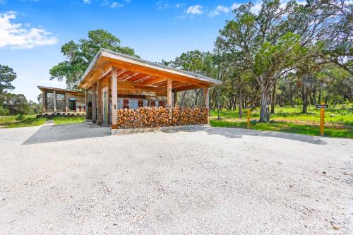 a small building with a roof on a dirt road at Wild Candy-Blue Yodel in Wimberley