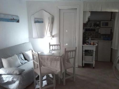 a living room with a table and a couch at La posada in Chiclana de la Frontera