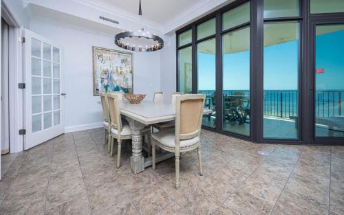 a dining room with a table and chairs at Phoenix West 603 in Orange Beach