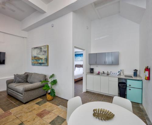 a kitchen and living room with a couch and a table at Casa Pelayo in San Juan