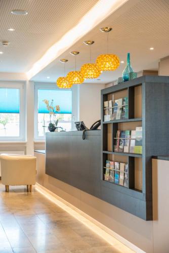 a waiting room with a book shelf and a desk at ateckhotel Kirchheim/Teck in Kirchheim unter Teck