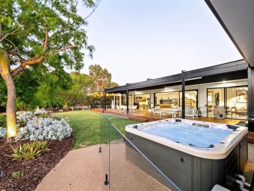 a hot tub in the backyard of a house at Seaview Yallingup - Nature & Spa Sanctuary in Yallingup
